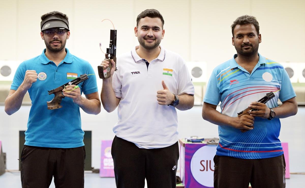 Anish Bhanwala (M-1st) flanked by Vijayveer Sidhu (R-2nd) and Ankur Goel (3rd) at the 25m rapid fire pistol men event during the Olympic selection trails three at the MP shooting academy in Bhopal.