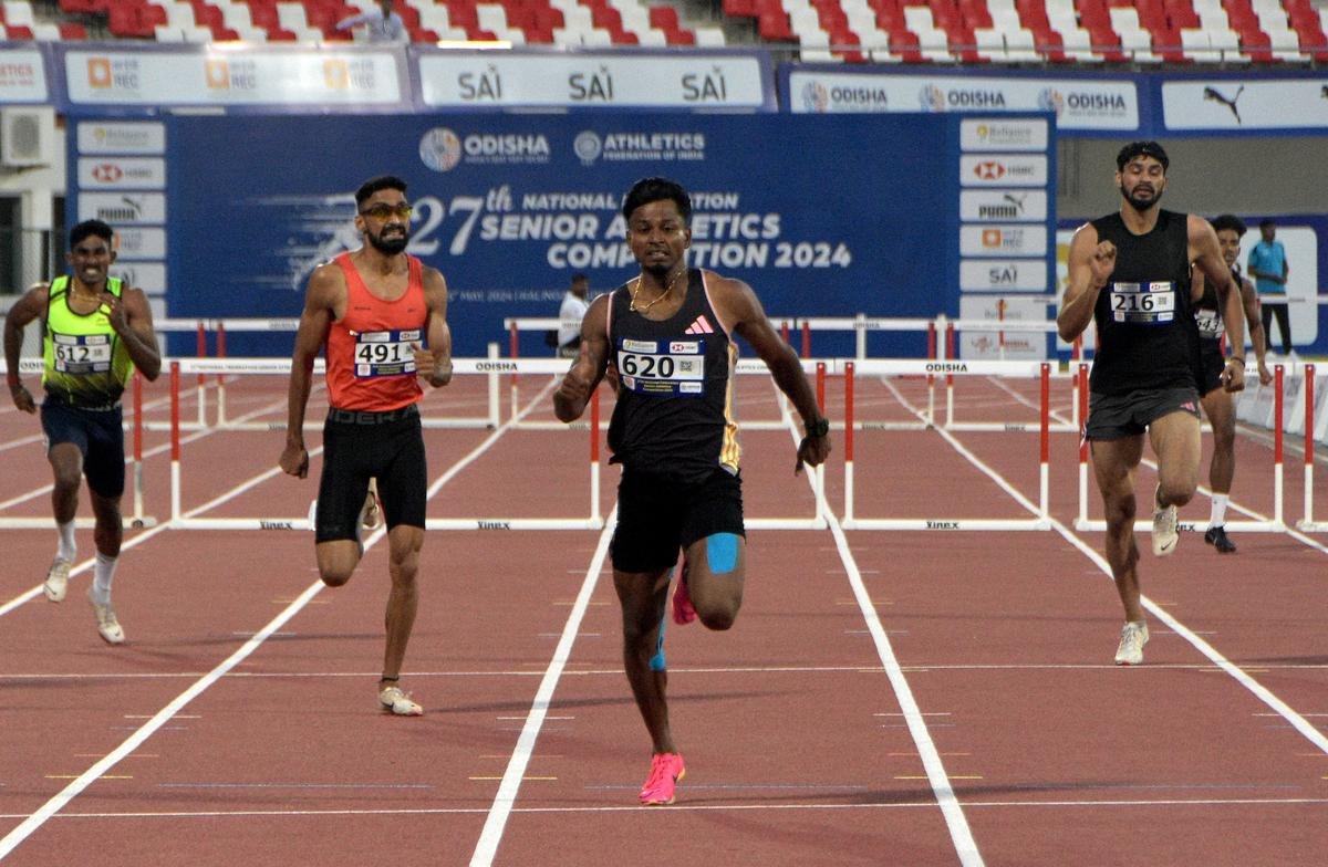 Tamil Nadu’s Santhosh Kumar (no. 620) runs in the 400m hurdles final. 