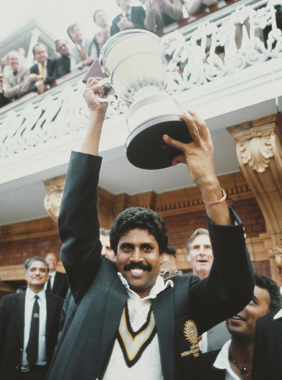 India captain Kapil Dev lifts the trophy on the balcony of the pavilion as Sunil Gavaskar (obscured right) looks on after the 1983 World Cup Final victory against West Indies.