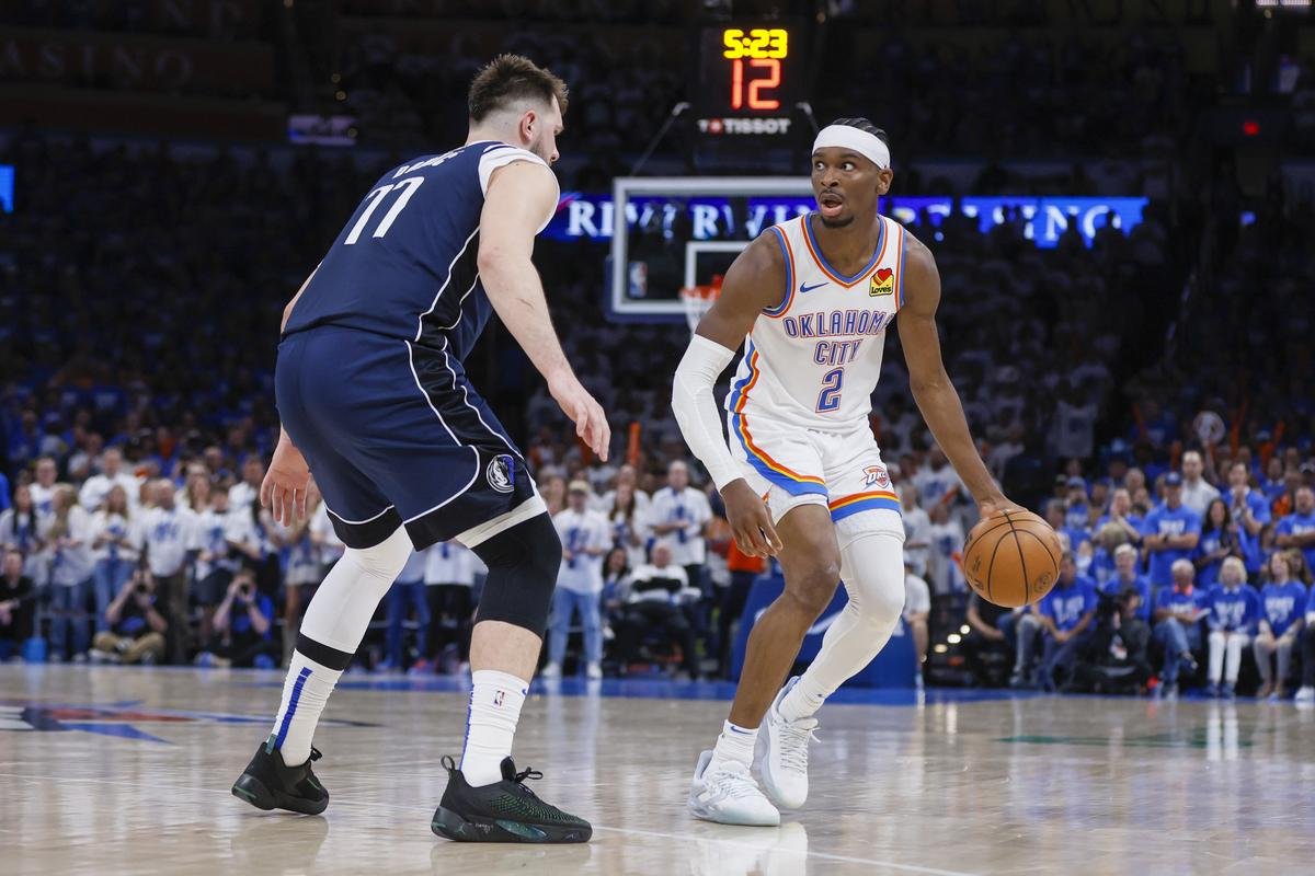Oklahoma City Thunder guard Shai Gilgeous-Alexander (2) works the floor against Dallas Mavericks guard Luka Doncic during the second half of Game 1 of an NBA basketball second-round playoff series.