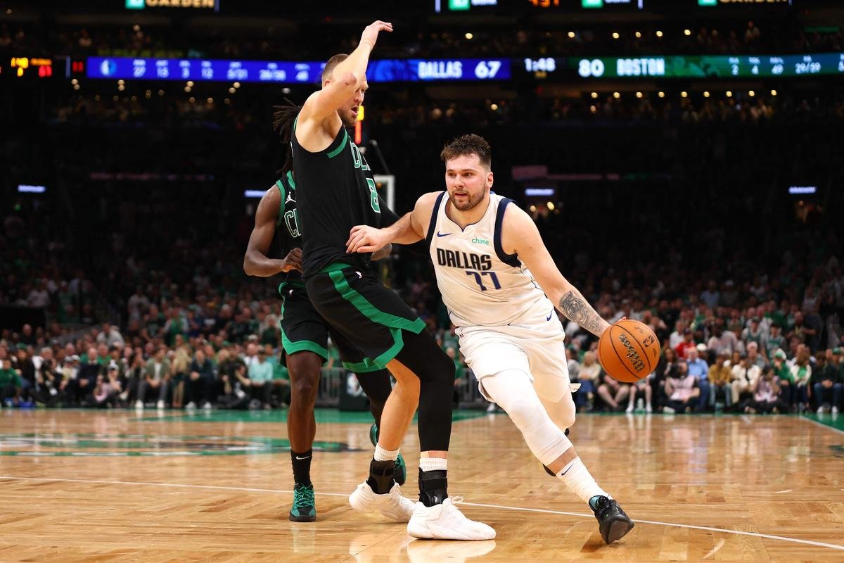 Doncic in action for Dallas Mavericks against Kristaps Porzingis of the Boston Celtics during the third quarter in Game Two of the 2024 NBA Finals.