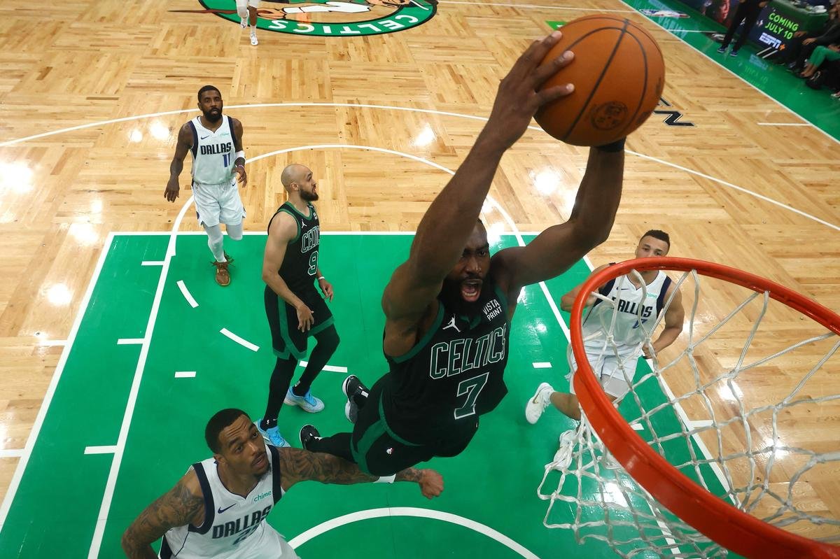 Jaylen Brown of Boston Celtics dunks the ball over P.J. Washington of the Dallas Mavericks in the 2024 NBA Finals.