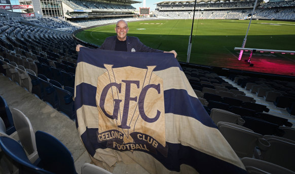 Bob Gartland, OAM, at GMHBA Stadium in Geelong with a Cats flag from the 1960s.