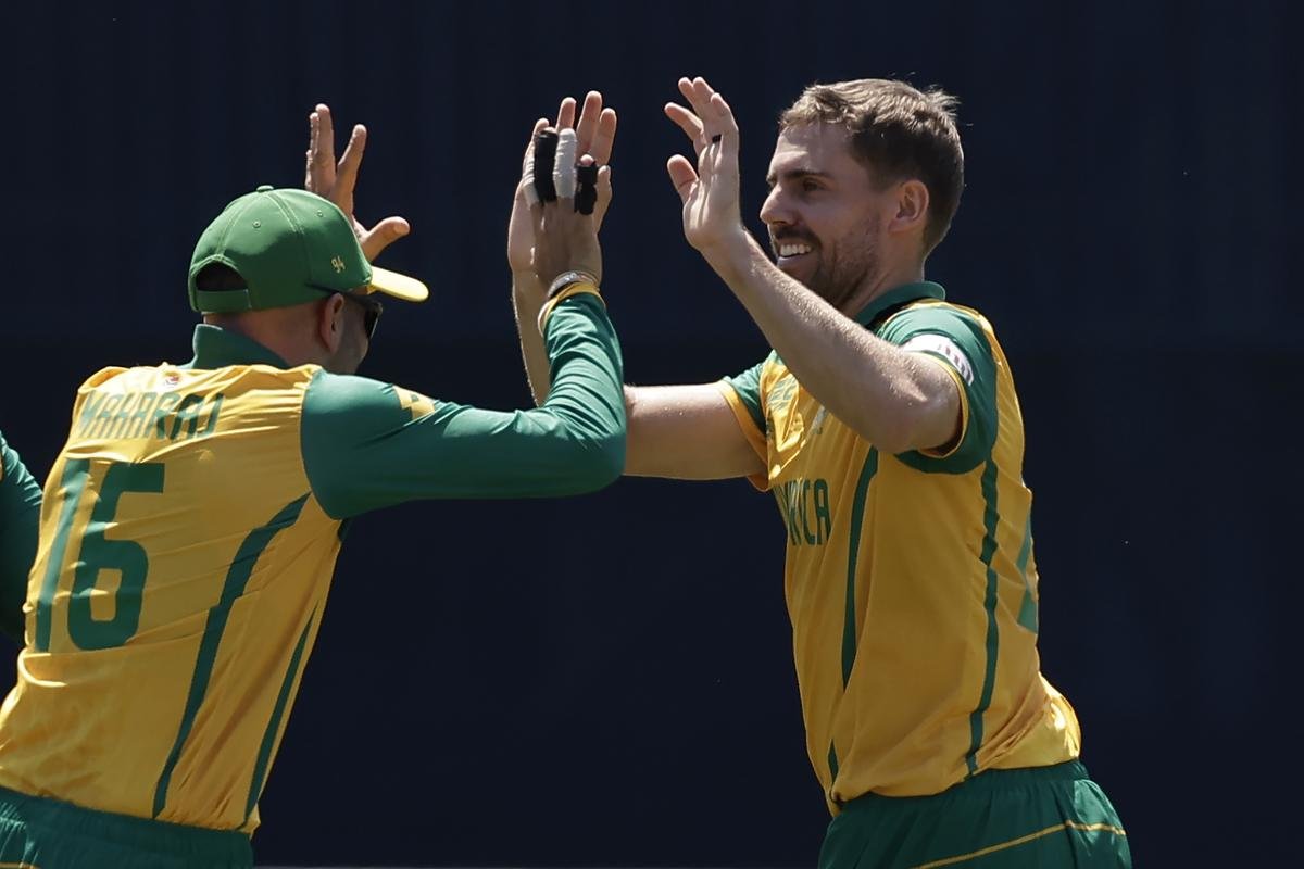 South Africa’s Anrich Nortje, right, celebrates with teammate Keshav Maharaj.