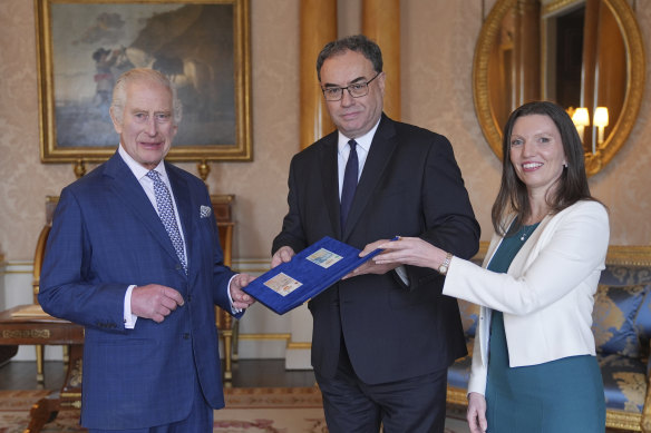 King Charles was presented with the first bank notes featuring his portrait by the Bank of England Governor Andrew Bailey, centre, and Bank of England’s Chief Cashier Sarah John, in April.