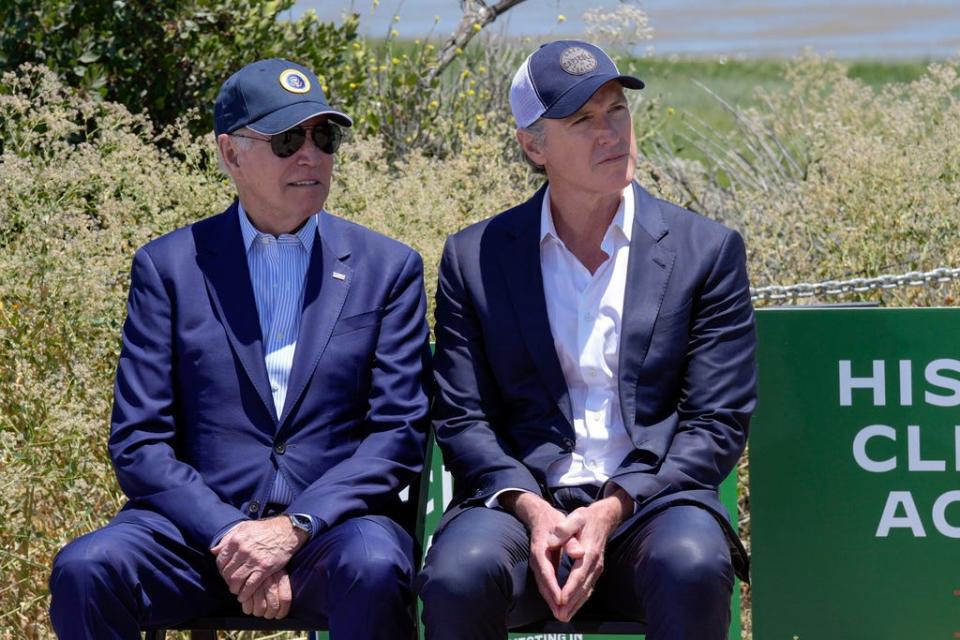 Joe Biden and Gavin Newsom wearing caps.