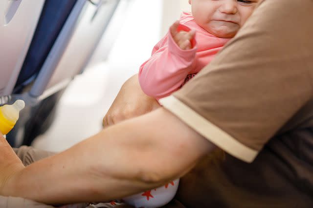 <p>romrodinka/Getty</p> A crying baby on a flight