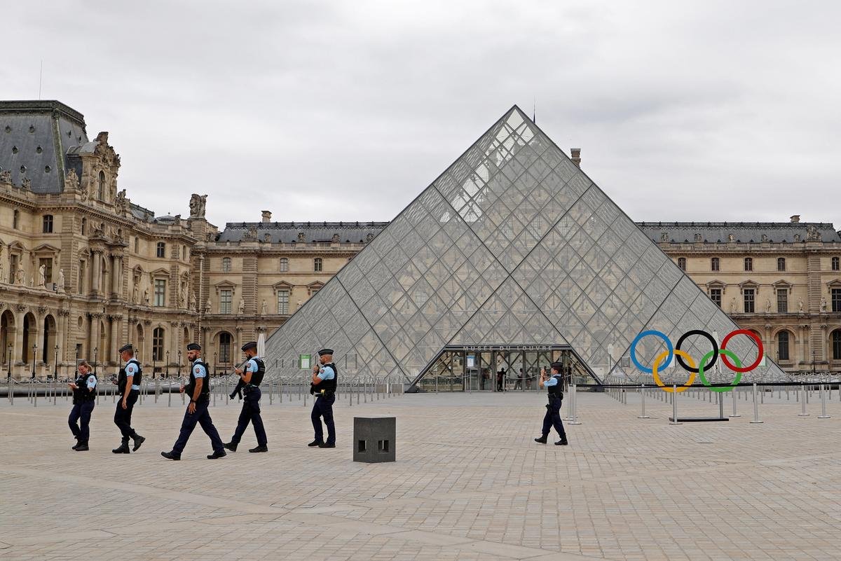 French gendarmes are seen near the Louvre Museum as the security perimeter for the opening ceremony is deployed ahead of the Paris 2024 Olympics.